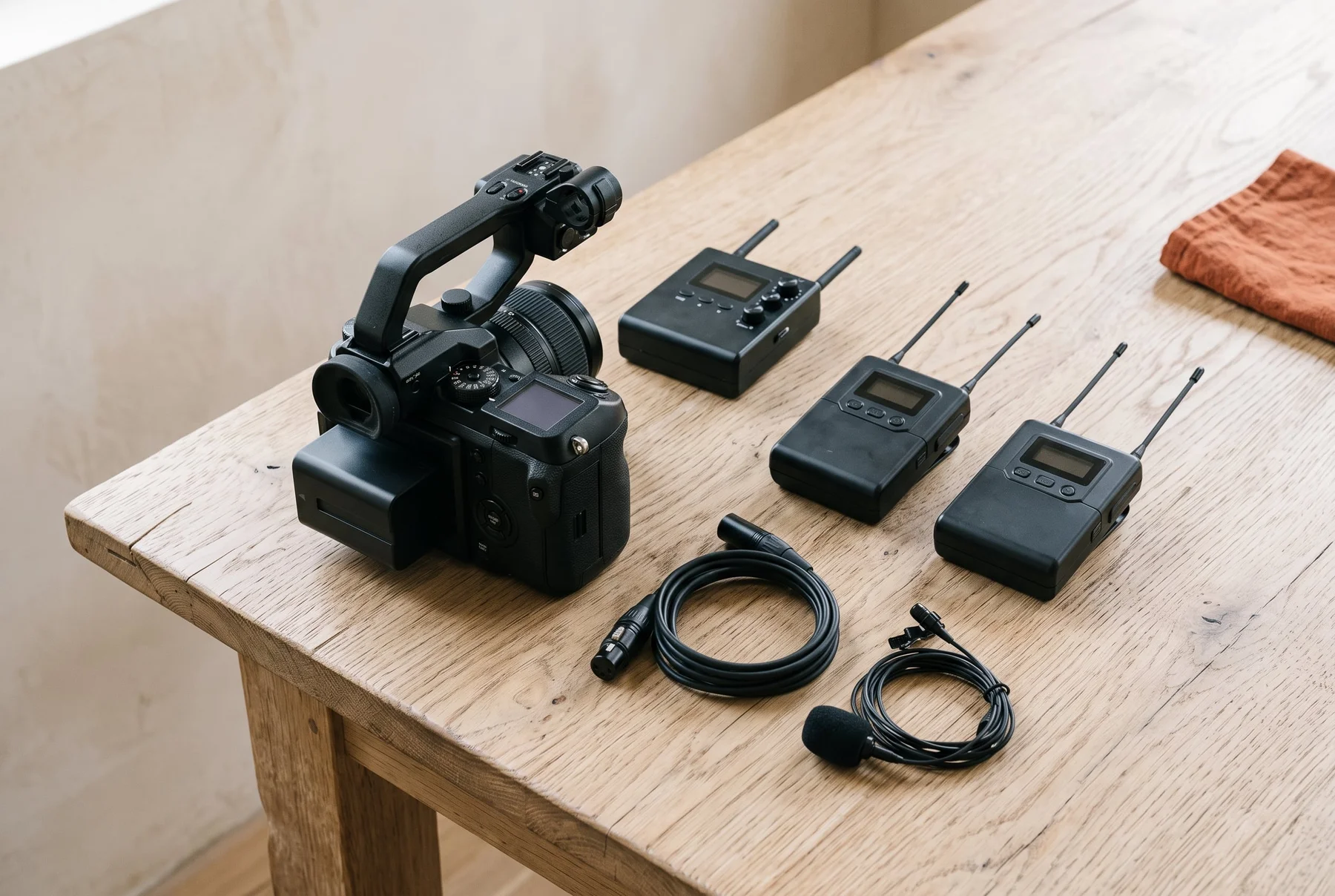 Illustration of a generic camera and portable wireless audio kit on a preparation table